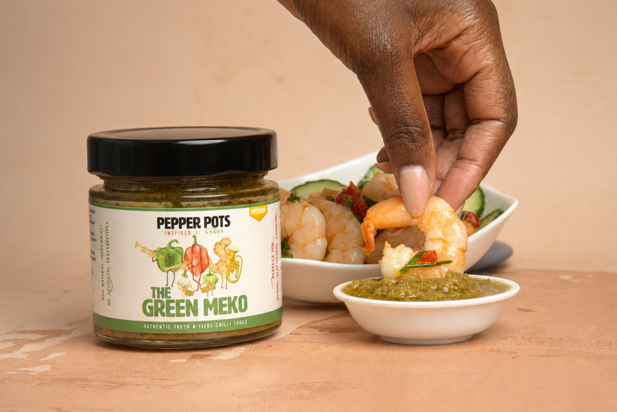 Cooked prawn dipped into Pepper Pots' Green Meko.