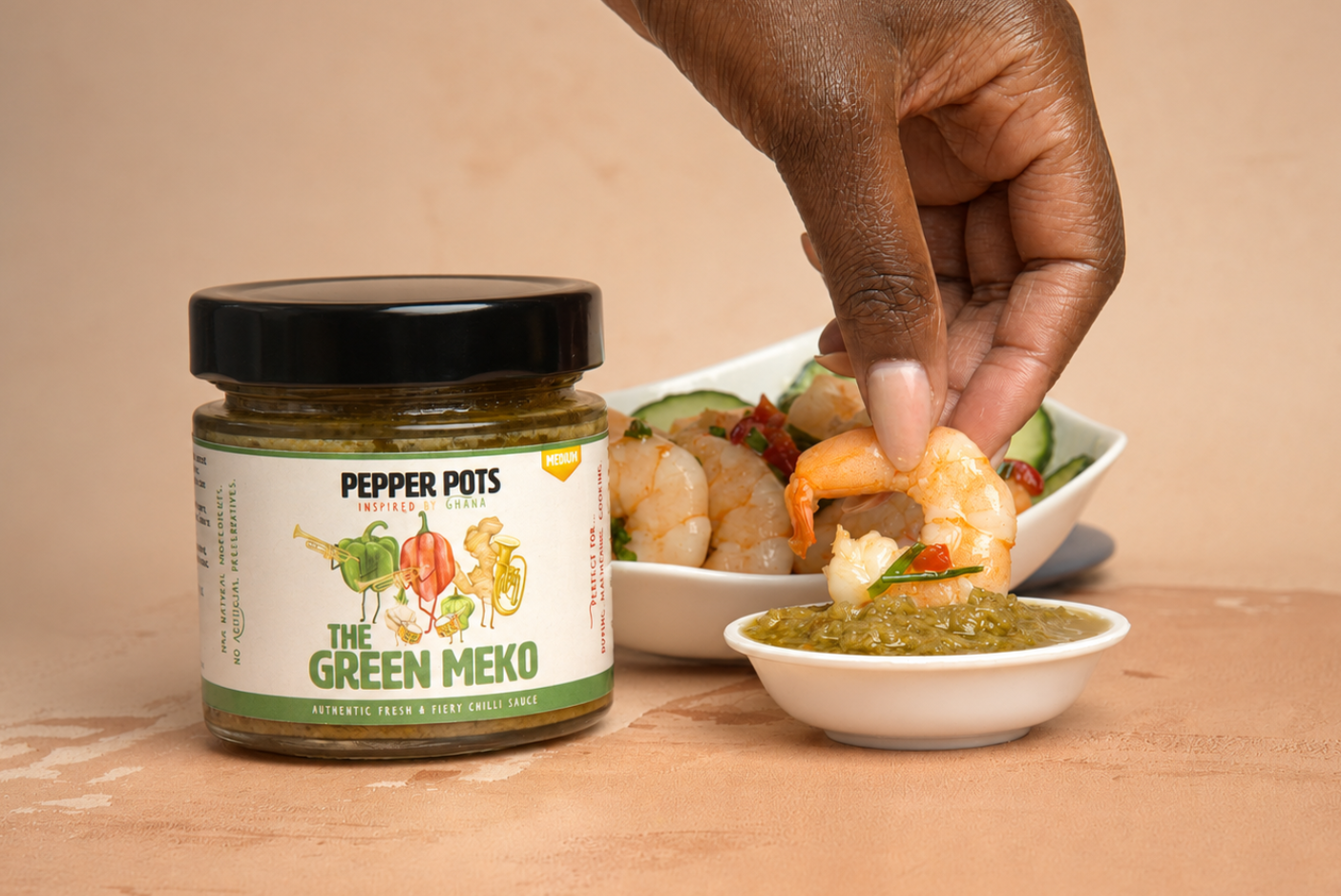 Cooked prawn dipped into Pepper Pots' Green Meko.